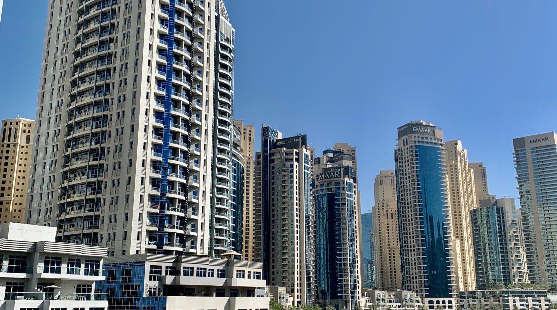 Außenansicht eines Wohnprojekts in Dubai mit gestalterischem Anspruch und begrünter Anlage